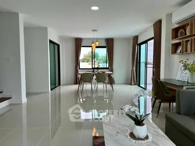 Spacious modern living room with dining area and large windows