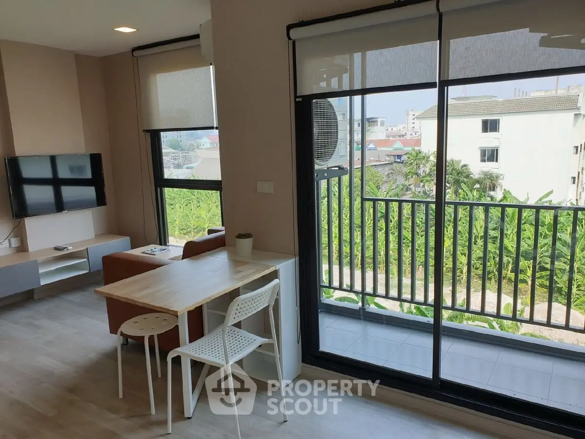 Modern living room with balcony view and stylish furniture in a bright apartment.