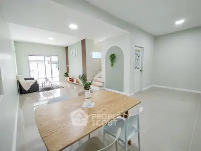 Spacious modern living and dining area with natural light and minimalist decor