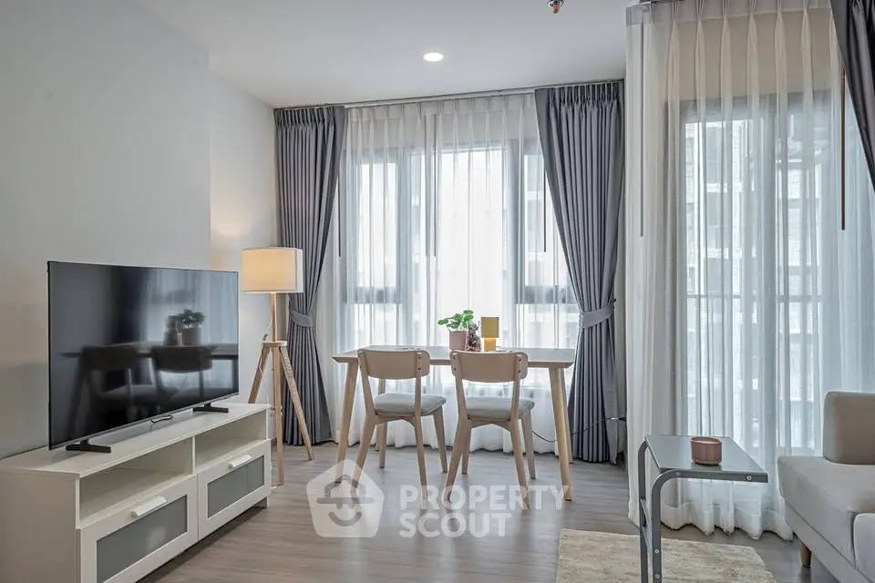 Modern living room with stylish furniture and large windows in a cozy apartment.