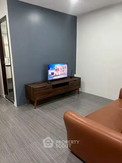 Modern living room with sleek TV stand and leather sofa
