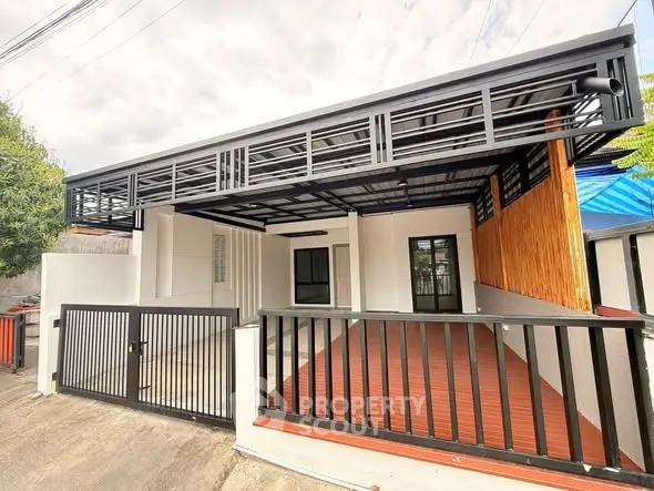 Modern single-story home with sleek metal accents and spacious carport.