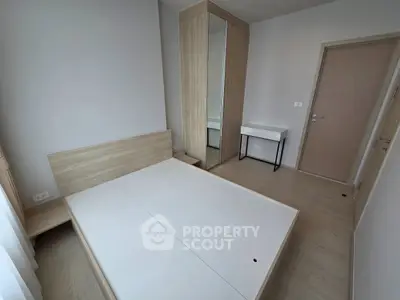 Modern minimalist bedroom with wooden furniture and built-in wardrobe