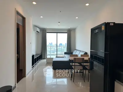 Modern living room with city view, sleek furniture, and open layout in a high-rise apartment.