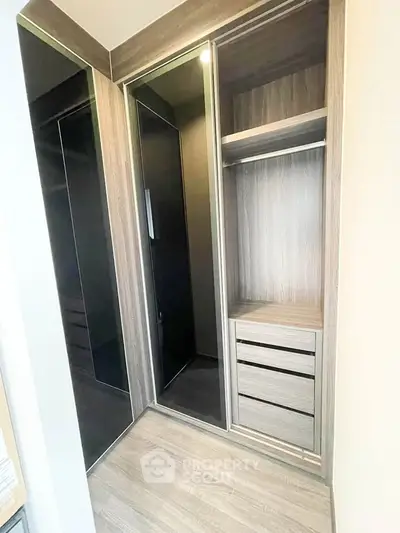 Spacious modern walk-in closet with sleek wooden finish and ample storage space.
