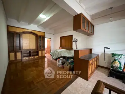 Spacious living room with wooden flooring and built-in cabinets, ideal for cozy family gatherings.