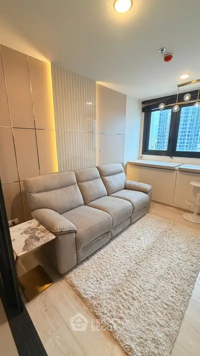 Modern living room with cozy sofa and city view window in high-rise apartment