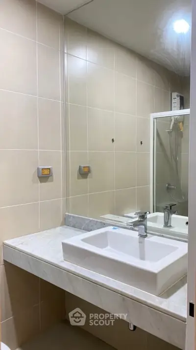 Modern bathroom with sleek sink and large mirror
