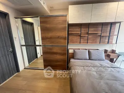 Modern bedroom with sleek wooden accents and built-in storage solutions.