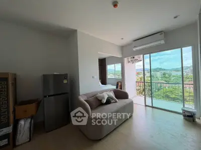 Modern living room with balcony view and compact kitchen setup