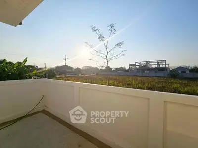 Stunning sunrise view from a spacious balcony overlooking serene landscape.