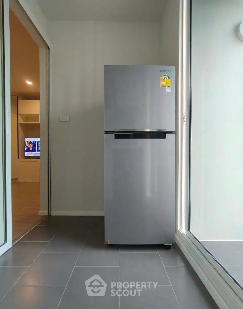 Modern kitchen with sleek refrigerator and sliding glass doors