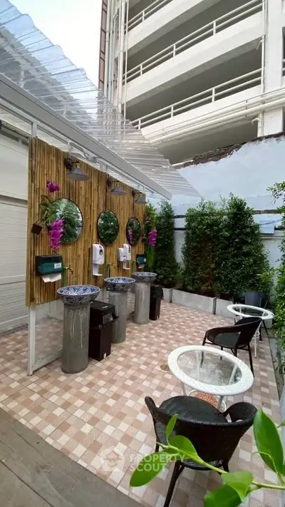 Chic outdoor wash area with stylish sinks and seating, perfect for modern urban living.