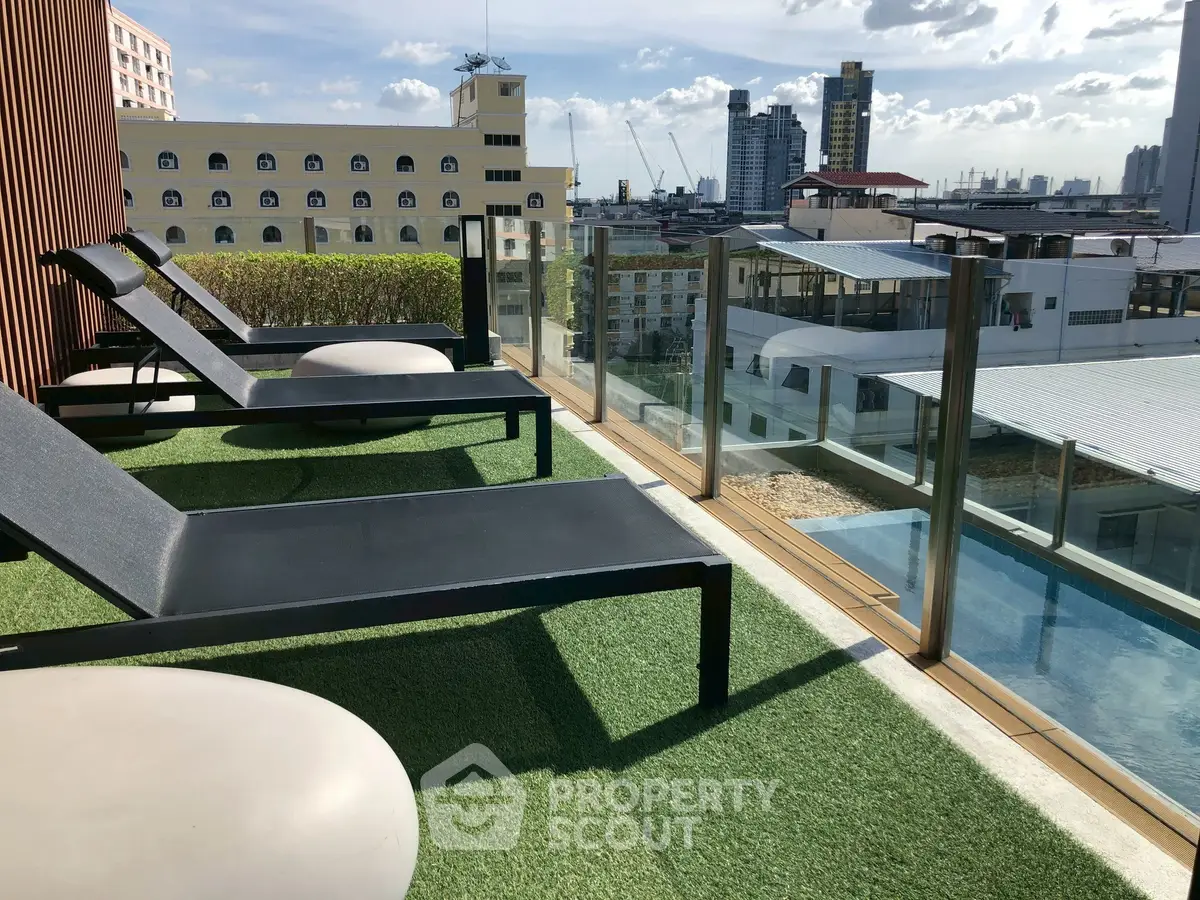 Luxurious rooftop pool area with stunning city views and modern lounge chairs.