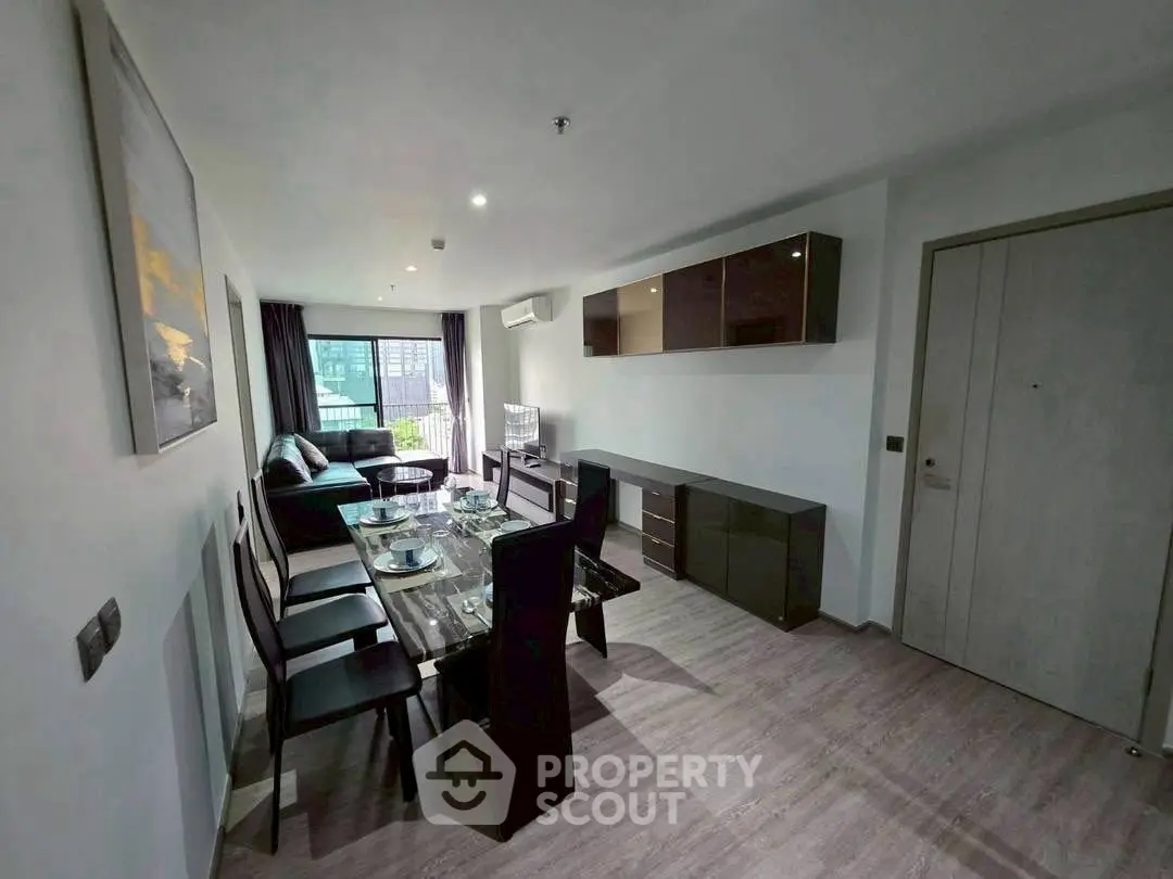 Modern living room with dining area and stylish furniture in a contemporary apartment.