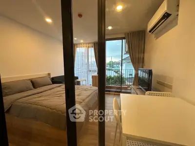 Modern studio apartment with cozy bedroom and balcony view
