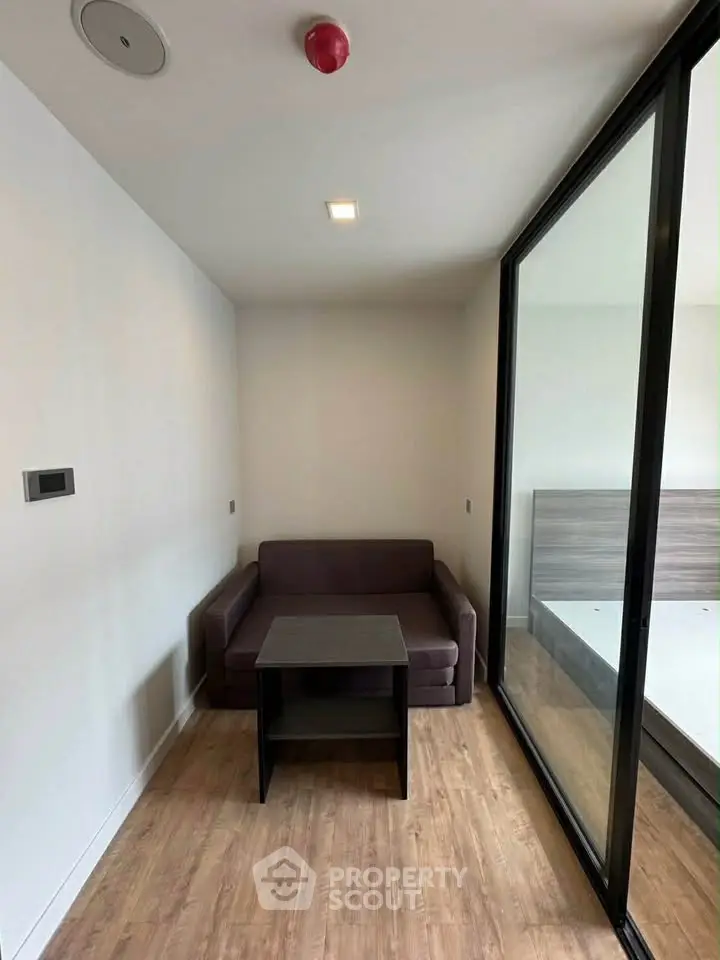 Modern compact living space with sleek design and glass partition