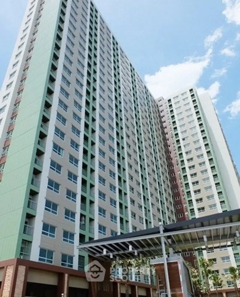 Modern high-rise apartment building with sleek design and spacious balconies.