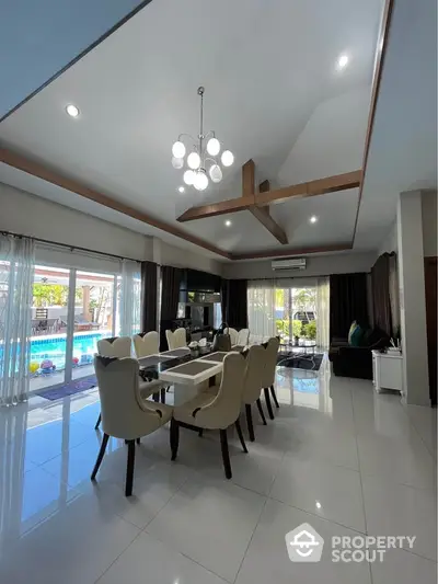 Luxurious dining room with pool view and elegant chandelier