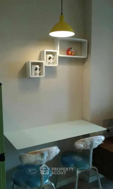 Modern study nook with stylish shelving and contemporary lighting