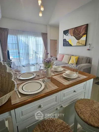 Stylish open-plan living room with elegant dining area and modern decor, perfect for contemporary living.