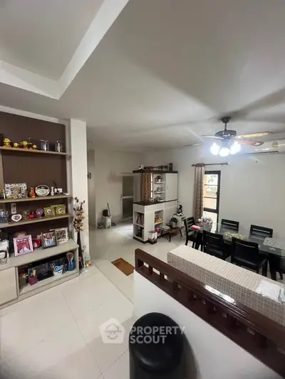 Spacious open-plan living and dining area with modern decor and ample natural light.