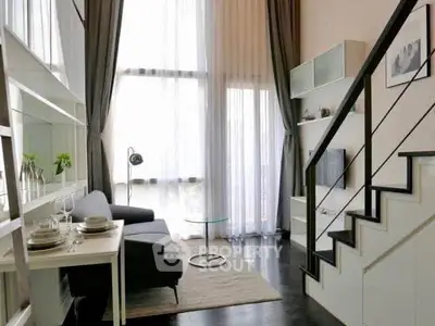 Modern living room with high ceilings, large windows, and stylish staircase in a chic apartment.