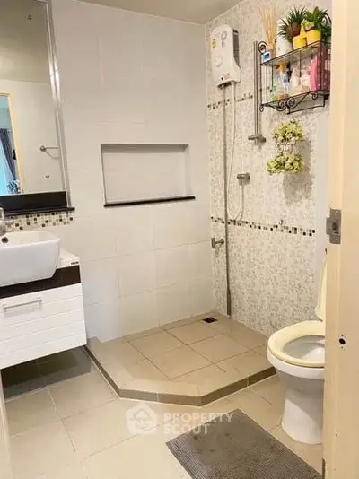 Modern bathroom with sleek fixtures and stylish tile design, featuring a shower and vanity.