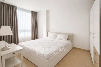 Bright and cozy bedroom with modern furnishings and ample natural light.