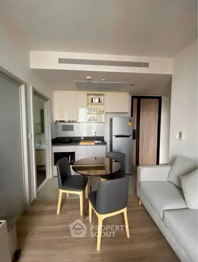 Modern apartment interior with compact kitchen and cozy living area