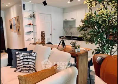 Modern open-plan living room with stylish kitchen and cozy seating area, perfect for entertaining.