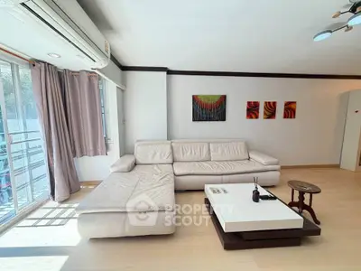 Spacious living room with modern white sectional sofa and natural light