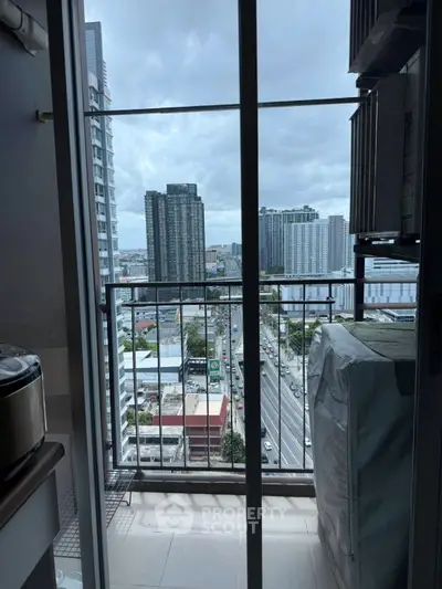High-rise apartment balcony with stunning city view and modern urban skyline.