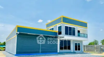 Modern two-story commercial building with large windows and garage doors, ideal for business use.