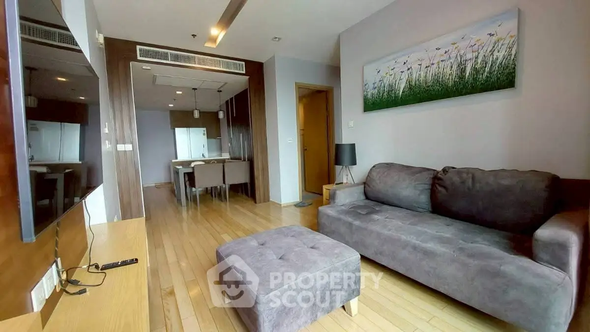 Modern living room with cozy sofa and open kitchen layout