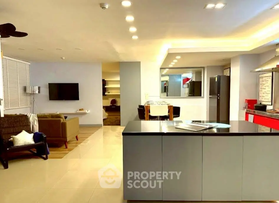 Modern open-plan living room with sleek kitchen island and stylish decor