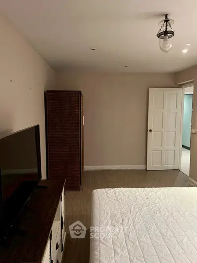 Spacious bedroom with modern decor and natural light