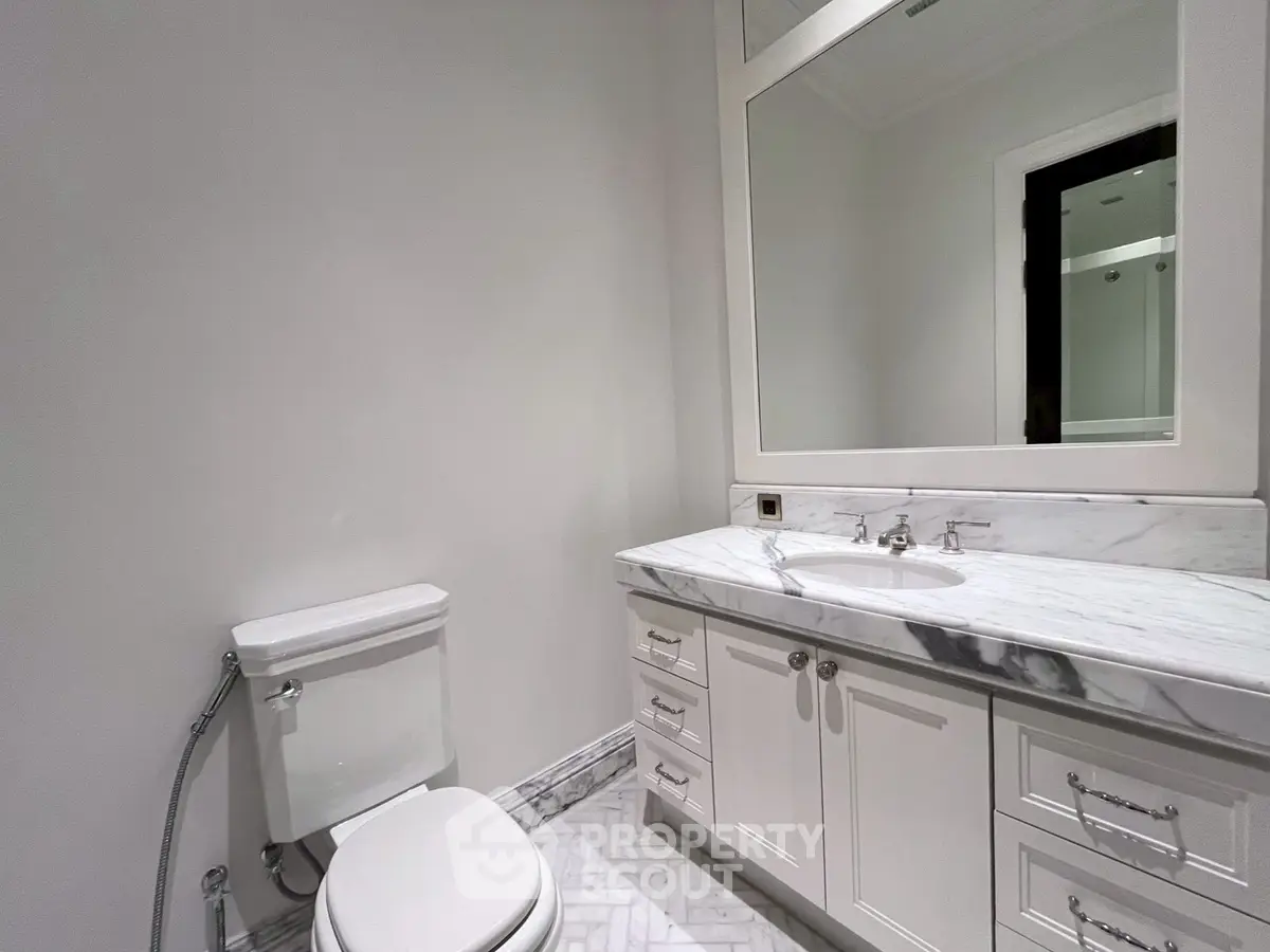 Elegant bathroom with marble countertop and modern fixtures.