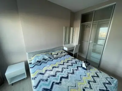 Modern bedroom with stylish decor and ample storage in a contemporary apartment.