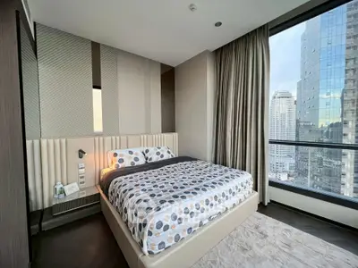 Modern bedroom with city view in high-rise apartment