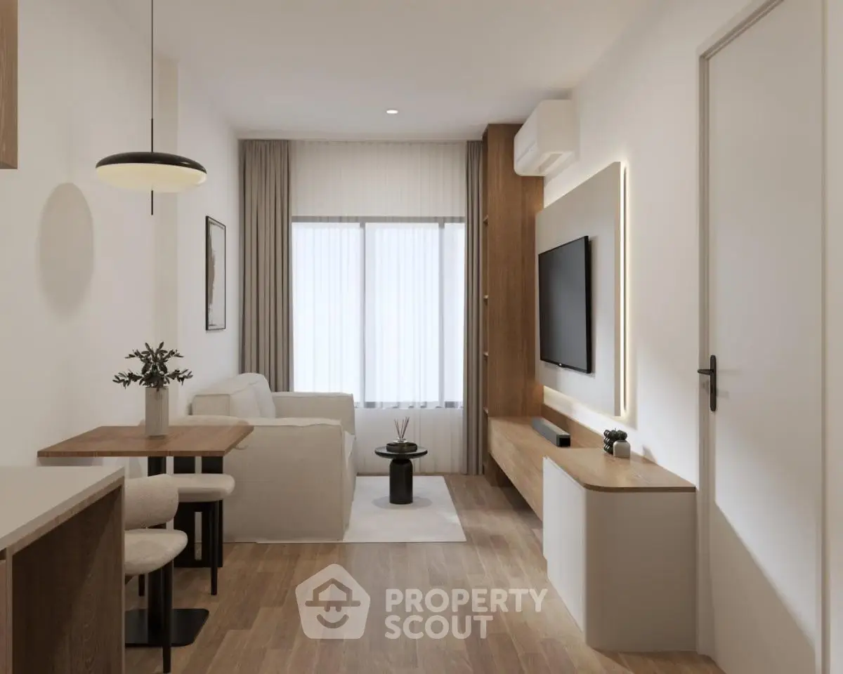 Modern living room with sleek furniture and natural light, featuring a wall-mounted TV and stylish decor.