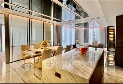 Luxurious open-plan living and dining area with elegant marble finishes and modern decor.