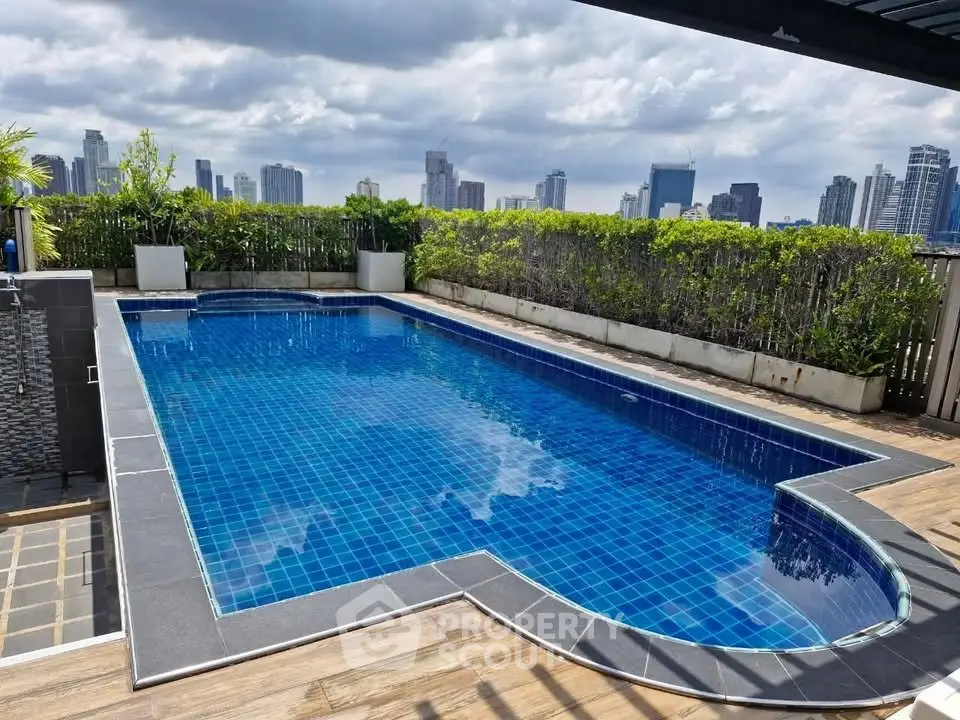 Luxurious rooftop pool with stunning city skyline views, perfect for relaxation and entertainment.
