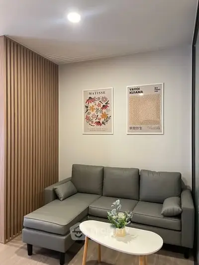 Modern living room with stylish gray sofa and wooden accent wall