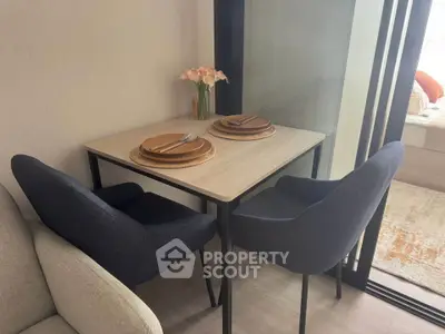 Cozy dining nook with elegant table setting and plush chairs in modern apartment.