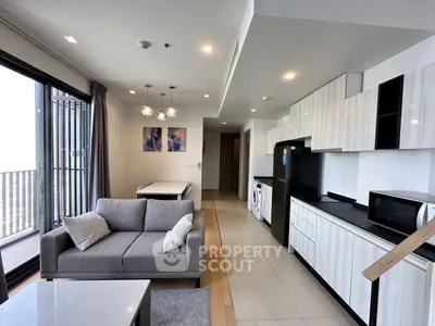 Modern open-layout living room and kitchen with balcony view