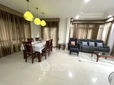 Spacious living room with elegant dining area and modern furnishings.