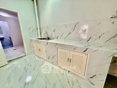 Modern kitchen with marble countertops and sleek cabinetry