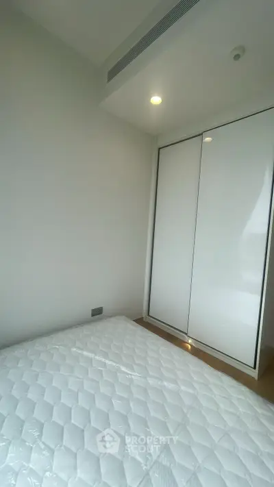 Modern bedroom with minimalist design and built-in closet