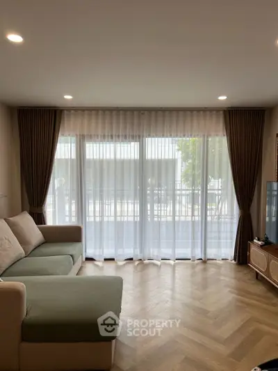 Spacious living room with large window and modern decor
